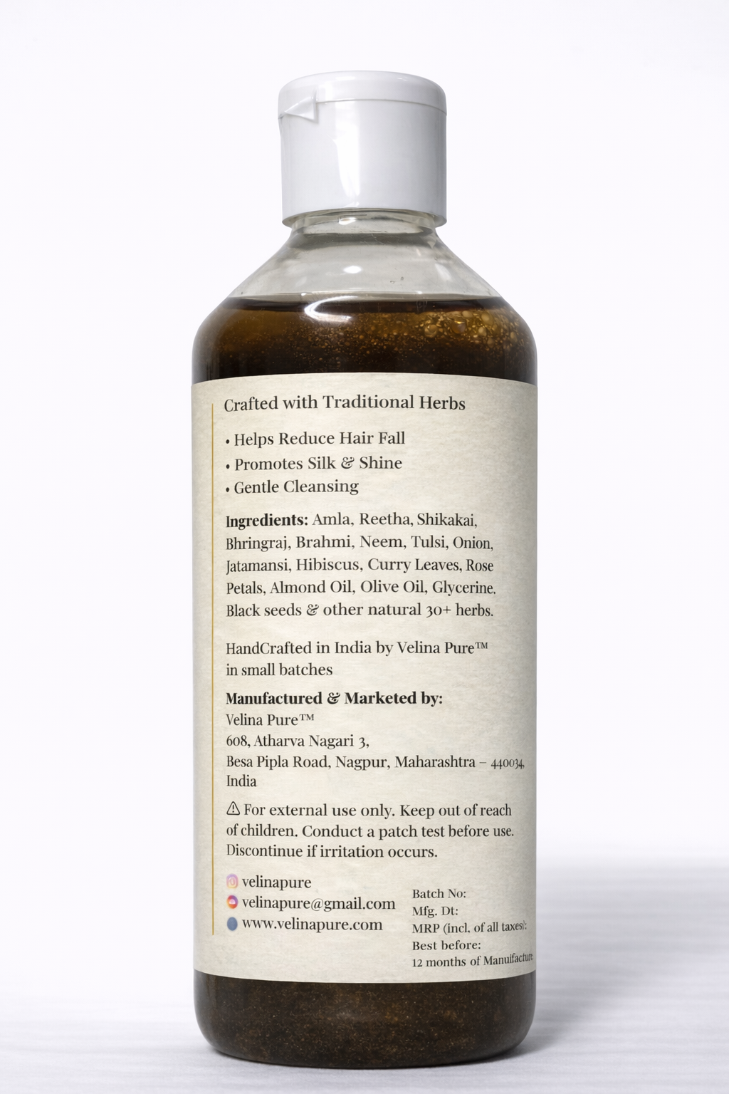Bottle of traditional herbal hair care product with label on a white background